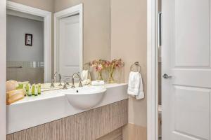 a bathroom with a sink and a large mirror at Stump Hill Estate - A Unique Stay with Mini Golf in McLaren Vale +17 photos
