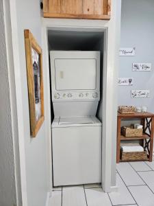 a refrigerator in a hallway with a door open at Toe River Retreat in Spruce Pine