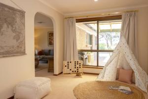 a childs bedroom with a pyramid bed and a window at 'Golden Homestead' A Panoramic Vineyard Escape in McLaren Vale