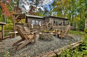 a backyard patio with chairs and a cabin at Blueberry Hill in McCaysville