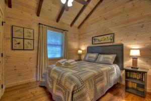 a bedroom with a bed in a log cabin at Blueberry Hill in McCaysville