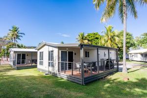 a mobile home with a deck and a house at BIG4 Tasman Holiday Parks - Rowes Bay in Townsville