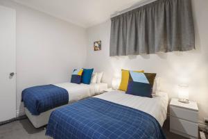 - 2 lits dans un dortoir bleu et blanc dans l'établissement Grand Luxury in the CBD along the Yarra River, à Melbourne