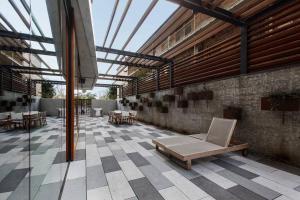 a building with a patio with a couch and tables at Executive Resort-Style Living at Leafy Albert Park in Melbourne