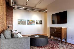 a living room with a couch and a table at The 611 Loft. Central Downtown Location. in Roanoke