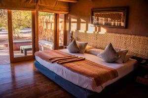 Ένα ή περισσότερα κρεβάτια σε δωμάτιο στο Hotel Cumbres San Pedro de Atacama