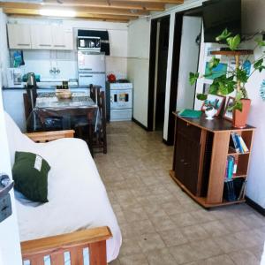 a kitchen and a living room with a table at MiDpto2 in San Carlos de Bariloche