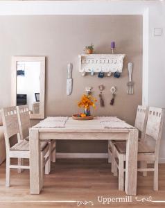 a dining room table with two chairs and a white table at Uppermill Suite #3 in Pécs