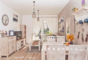 a dining room with a table and chairs and a window at Uppermill Suite #3 in Pécs