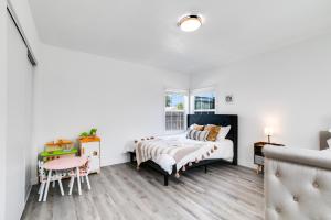a bedroom with two beds and a table at Modern Home - Family Fun Hub - Getaway - Billiards By Zen Living Short Term Rental in Glendora