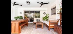 a living room with a wooden table and benches at Siesta Key Home with pool/hot tub 12 min to beach in Sarasota