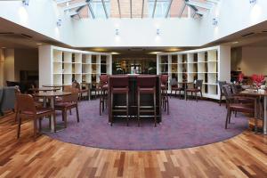 a dining area with tables and chairs in a library at Park Inn by Radisson Birmingham Walsall in Walsall