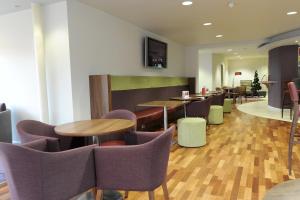 a restaurant with tables and chairs in a room at Park Inn by Radisson Birmingham Walsall in Walsall