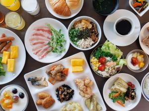 a table full of plates of food with different foods at JR Kyushu Hotel Kagoshima in Kagoshima