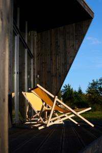 a bench sitting on the porch of a building at CloudBase in Tukhlya
