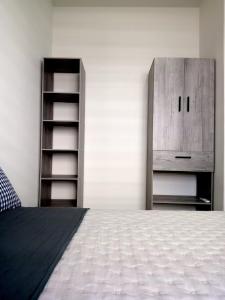 a bedroom with a bed and a wooden cabinet at Casa Valtierra, La Paz in La Paz