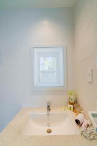 a white sink in a bathroom with a window at CHUONG DUONG HOTEL in My Tho