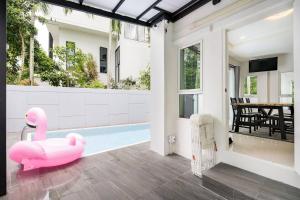 a pink inflatable flamingo sitting on the floor of a house at golf pool villa close patong and phuket town in Kathu