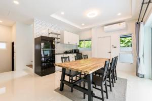 a kitchen and dining room with a wooden table and chairs at golf pool villa close patong and phuket town in Kathu