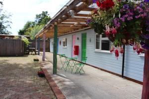 a white house with a green door and flowers on it at The Great Escape - Pet Friendly - Pets stay FREE in Rye