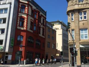 a group of people riding bikes on a city street at Hostel Heinzelmännchen in Cologne