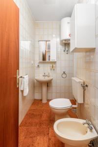 La salle de bains est pourvue de toilettes et d'un lavabo. dans l'établissement Apartments with a parking space Rabac, Labin - 19055, à Rabac