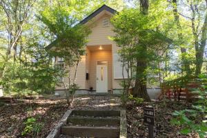 a house with a white door in the woods at S-villa Nasu 8th in Nasu +25 photos