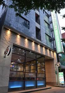 a store front of a building with lights on it at Nissei Hotel Fukuoka in Fukuoka