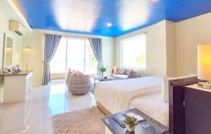 a bedroom with a bed and a blue ceiling at Boracay Ocean Club Beach Resort in Boracay
