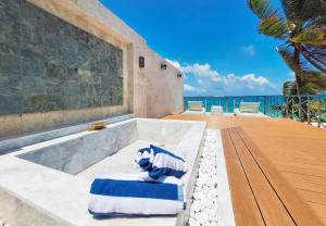 a bath tub with a blue and white towel at Boracay Ocean Club Beach Resort in Boracay