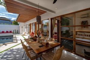 a dining room with a wooden table and chairs at *NEWLY Renovated* 2BD Stylish Villa! in Kerobokan