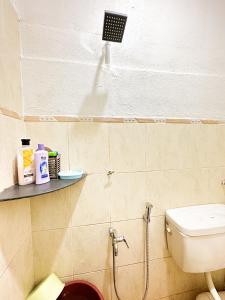 a bathroom with a shower head and a toilet at Dusun Indah Cottage 1 in Bayan Lepas