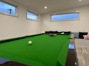 a living room with a green pool table at PepperTree Farm Stay in Grassy