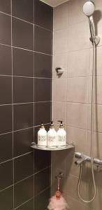 a bathroom with a shower with three soap bottles at The Seoul House YDP - Foreigners Only in Seoul