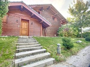 a wooden house with stairs in front of it at Chalet Méribel, 5 pièces, 8 personnes - FR-1-688-64 in Méribel