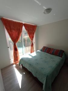 a bedroom with a bed and a large window at Departamento nuevo 1D1B estacionamiento privado gratis in Viña del Mar