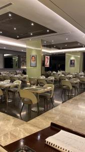 a dining room filled with tables and chairs at Serviced Apartments @ Times Square Kuala Lumpur in Kuala Lumpur