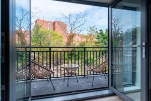 a balcony with two chairs and a table at Modern 2 Bedroom Apartment in Quincy in Quincy