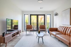 a living room with a couch and a table at Modern 2 Bedroom Apartment in Quincy in Quincy