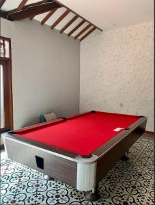a pool table in a room with a red top at Rumah Canda in Bandung
