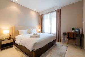 a bedroom with a bed and a desk and a window at Park view Avalon Apartment District 1 HCM City in Ho Chi Minh City