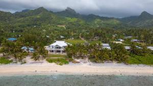 an aerial view of a resort on a beach at ShineAwayHomes - Mountain View AIR CONDITIONED in Rarotonga
