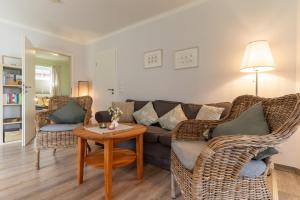 a living room with a couch and chairs and a table at FeWo Haus Friesenkind in Garding