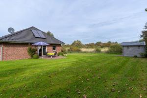 a house with a large lawn in front of it at FeWo Haus Friesenkind in Garding
