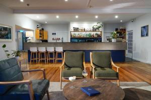 a living room with chairs and a table and a bar at The Portage Resort in Portage