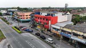 an aerial view of a city with a red building at Lux Hotel in Teluk Intan