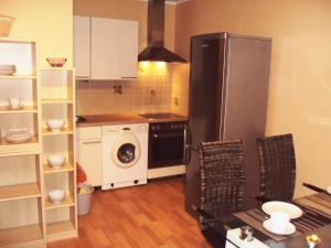 a kitchen with a refrigerator and a washer and dryer at Offenburg Apartment in Offenburg