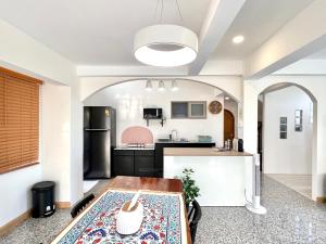 an open kitchen with a table in a room at SOVA Vcay Pool Villa in Ban Yai La
