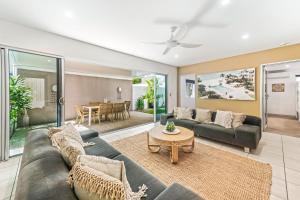 a living room with a couch and a table at Alex Beach House in Alexandra Headland
