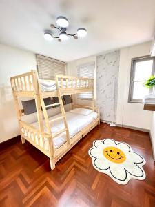 a bedroom with a bunk bed with a flower rug at SOVA Vcay Pool Villa 
